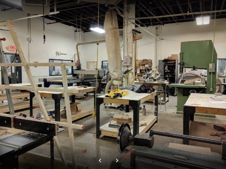 A picture containing indoor, floor, room, working